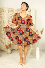 orange african print mini dress with puff sleeves and side pockets.
